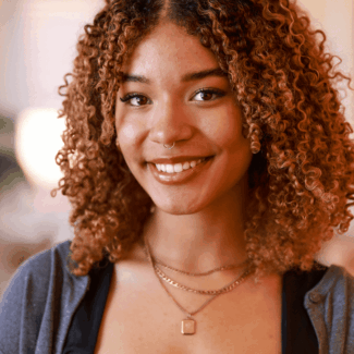 Carina Laventure smiling at the camera from the Vital Voices headquarters.