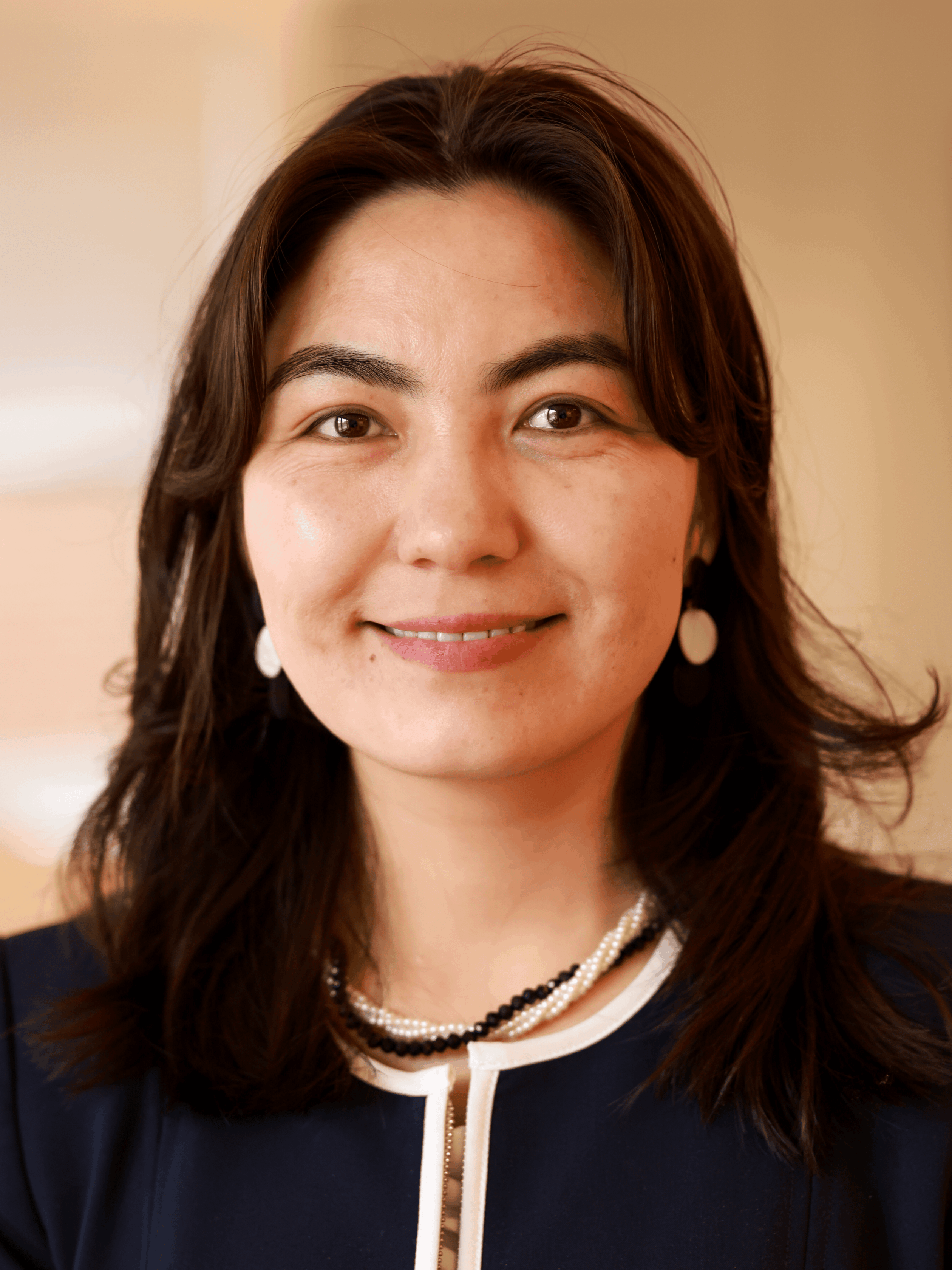Khadijah Nazari smiling at the camera from the Vital Voices Community Hub.