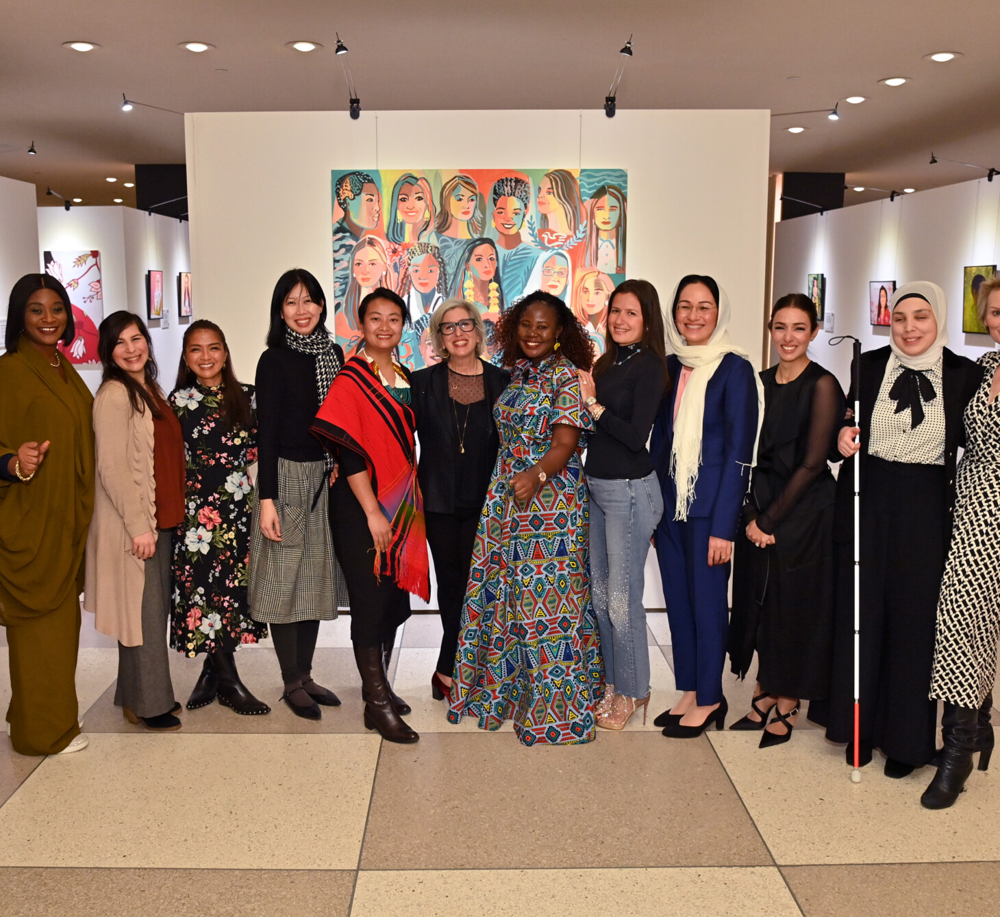 NEW YORK, NEW YORK - FEBRUARY 29: (L-R) Annemarie Hou, Dr Yetunde Ayo-Oyalowo, Aline Sara, Leah Lizarondo, Michelle Hong, Zeinorin Angkang, Gayle Kabaker, Hellen Lunkuse Waiswa Tanyinga, Inna Braverman, Shirin Musa, Sarah El Battouty, Sara Minkara and Alyse Nelson attend the Vital Voices Women’s History Month reception for the unveiling of “Portraits of Progress: Women Powering the Global Goals,” an interactive art exhibit about women leaders who are solving the Sustainable Development Goals at the United Nations Headquarters in New York in collaboration with the UN Office of Partnerships  (Photo by Bryan Bedder/Getty Images for Vital Voices Global Partnership )