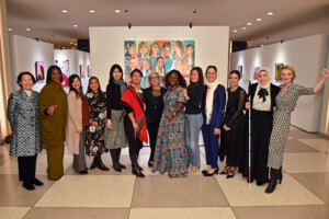 NEW YORK, NEW YORK - FEBRUARY 29: (L-R) Annemarie Hou, Dr Yetunde Ayo-Oyalowo, Aline Sara, Leah Lizarondo, Michelle Hong, Zeinorin Angkang, Gayle Kabaker, Hellen Lunkuse Waiswa Tanyinga, Inna Braverman, Shirin Musa, Sarah El Battouty, Sara Minkara and Alyse Nelson attend the Vital Voices Women’s History Month reception for the unveiling of “Portraits of Progress: Women Powering the Global Goals,” an interactive art exhibit about women leaders who are solving the Sustainable Development Goals at the United Nations Headquarters in New York in collaboration with the UN Office of Partnerships  (Photo by Bryan Bedder/Getty Images for Vital Voices Global Partnership )